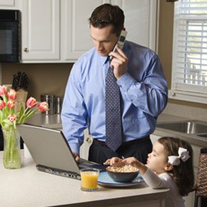 man working on computer with child