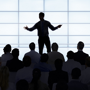 person speaking in front of a crowd