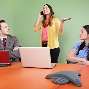 woman chatting on her phone in a meeting