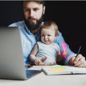 online student studying with a child on his lap