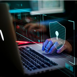 person in front of laptop following steps to protect themselves from being hacked