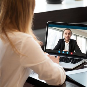 woman talking to man on computer