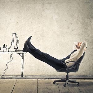 someone kicked back in their desk chair thinking deeply