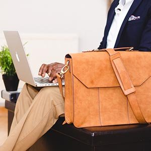 person with briefcase and computer