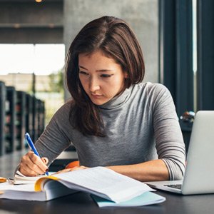 woman writing on paper