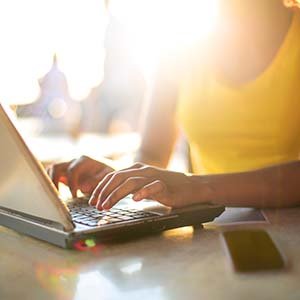Girl working with her laptop in a bar