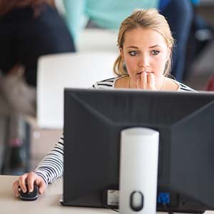 girl looking at computer