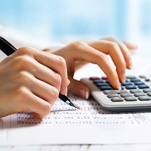 Accountant At Work with a calculator