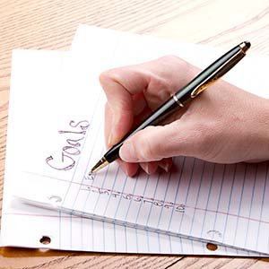 person writing goals