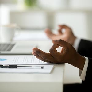 man meditating at desk