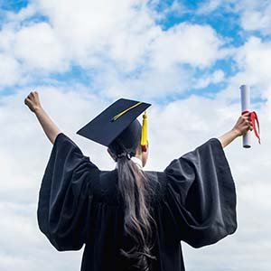 graduate with arms in victory